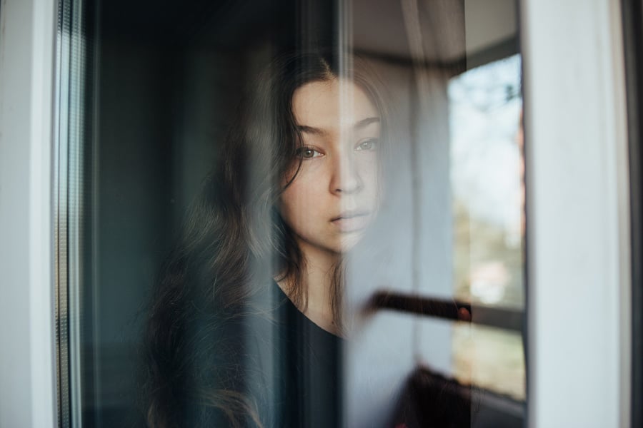 A woman looking out of a window