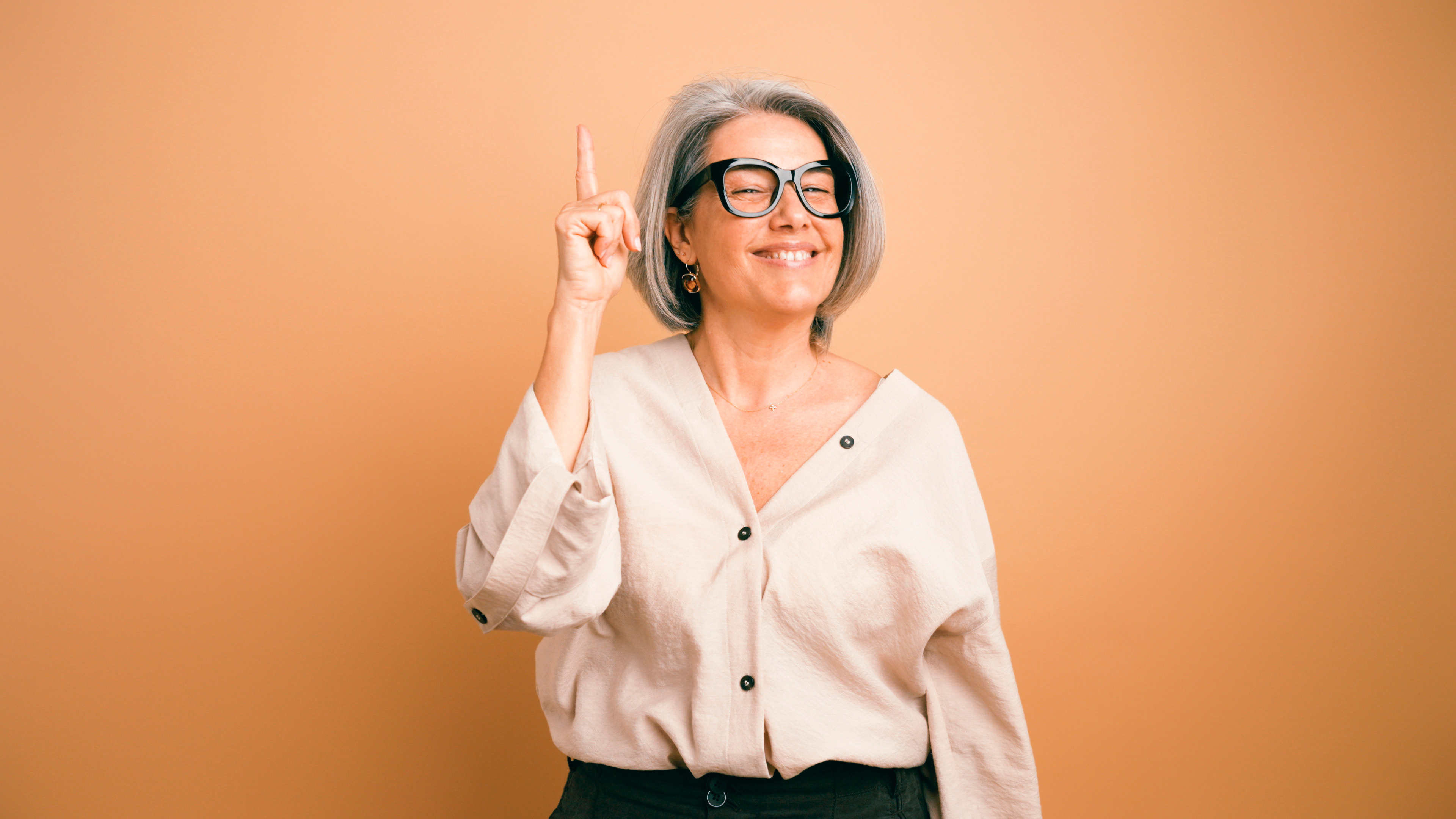 A woman pointing upwards 